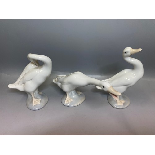 228 - FOUR LLADRO FIGURES OF BEDTIME CHILDREN AND A TRIO OF GEESE