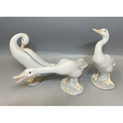 228 - FOUR LLADRO FIGURES OF BEDTIME CHILDREN AND A TRIO OF GEESE