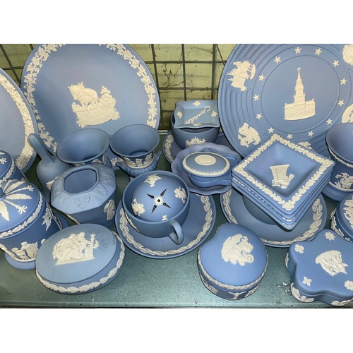 211 - SHELF OF WEDGWOOD POWDER BLUE JASPERWARE COMMEMORATIVE PLATES, DECORATIVE BELLS, POWDER BOXES AND TR... 