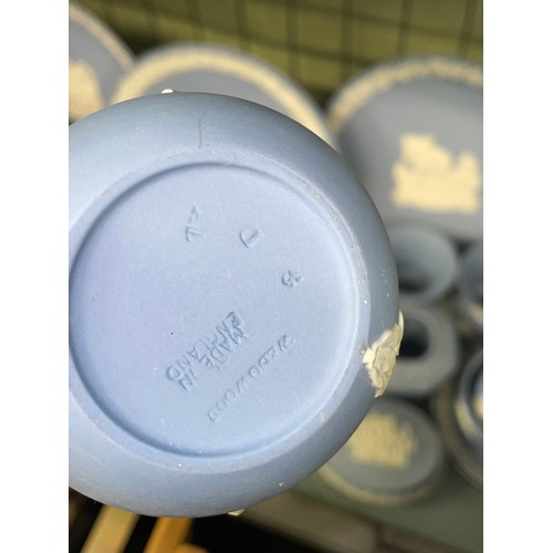 211 - SHELF OF WEDGWOOD POWDER BLUE JASPERWARE COMMEMORATIVE PLATES, DECORATIVE BELLS, POWDER BOXES AND TR... 