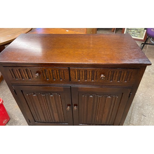 36 - OAK LINEN FOLD TWO DOOR SIDE CABINET