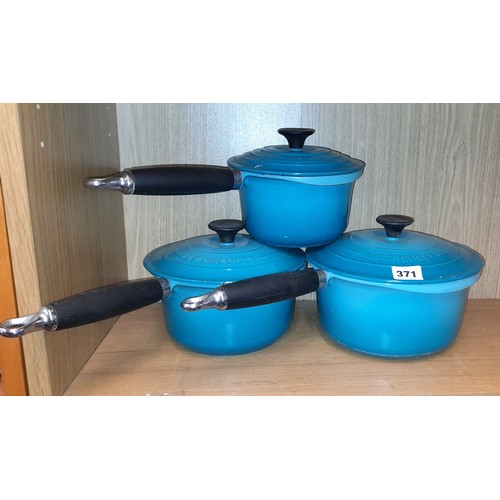 219 - THREE LE CREUSET TURQUOISE SAUCEPANS AND COVERS