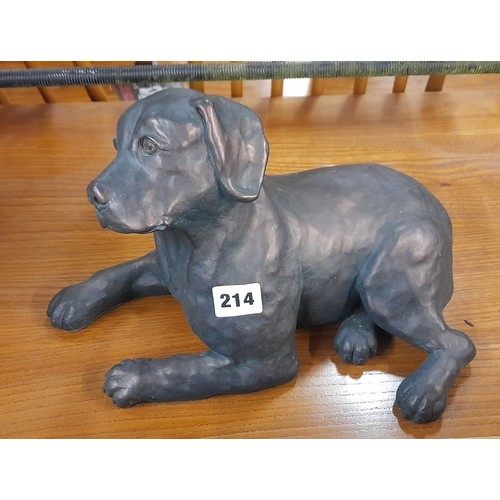 214 - PATINATED RESIN RECUMBENT PUPPY MODEL