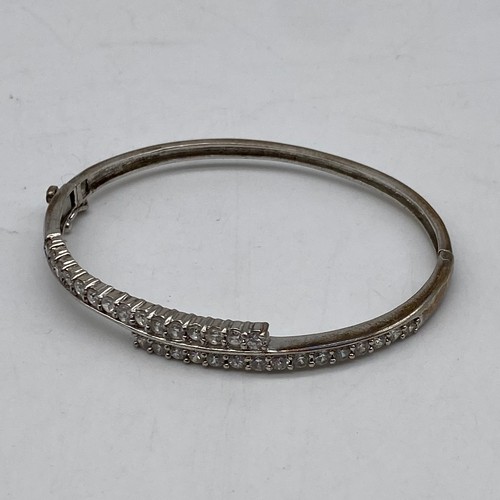 515 - SILVER ENGRAVED CUFF BRACELET WITH SAFETY CHAIN, FILLIGREE BANGLE, CZ CROSS OVER BANGLE, AND OTHER B... 