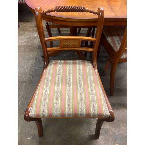 8 - REPRODUCTION YEW REGENCY STYLE DINING TABLE WITH FOUR SABRE LEG BRASS INLAID ROPE BACK CHAIRS