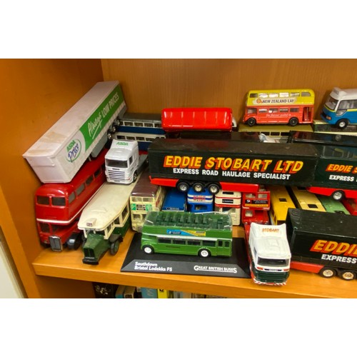 285 - TWO SHELVES OF DIE CAST MODELS OF DOUBLE DECKER BUSES, COACHES AND SOME EDDIE STOBART HAULAGE TRUCKS... 