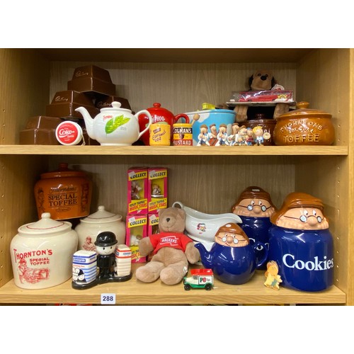 288 - TWO SHELVES OF TETLEY TEA FOLK AND RELATED ADVERTISING WARES AND CONFECTIONARY STORAGE JARS, TEAPOTS... 