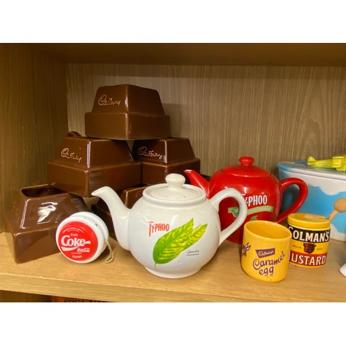 288 - TWO SHELVES OF TETLEY TEA FOLK AND RELATED ADVERTISING WARES AND CONFECTIONARY STORAGE JARS, TEAPOTS... 