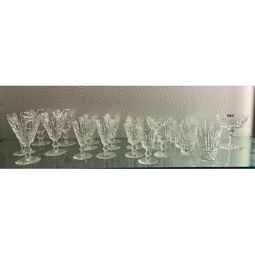 340 - SHELF OF WATERFORD CRYSTAL TRAMORE DRINKING GLASSES INCLUDING BEAKERS, GOBLETS, AND CHAMPAGNE FLUTES