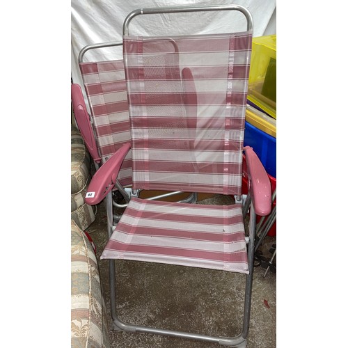 28 - PAIR OF PINK AND WHITE STRIPED FOLDING GARDEN ARMCHAIRS