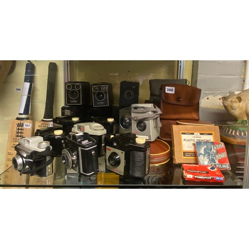 300 - TOP SHELF OF KODAK BOXED BROWNIE AND EARLY 35M CAMERAS AND ACCESSORIES'