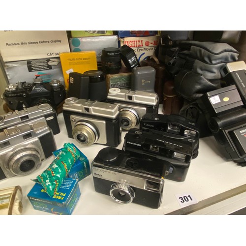 301 - TWO SHELVES OF 35MM CAMERAS INCLUDING ZENIT, VARIOUS LENSES, MIRANDA FLASH GUN, DISC CAMERA OUTFITS ... 