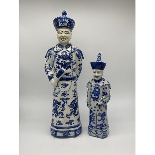 386 - THREE CHINESE BLUE AND WHITE AND DECORATIVE EMPEROR FIGURES