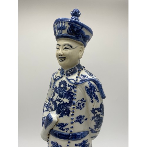 386 - THREE CHINESE BLUE AND WHITE AND DECORATIVE EMPEROR FIGURES