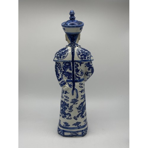 386 - THREE CHINESE BLUE AND WHITE AND DECORATIVE EMPEROR FIGURES