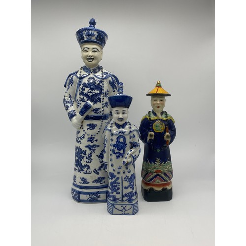 386 - THREE CHINESE BLUE AND WHITE AND DECORATIVE EMPEROR FIGURES