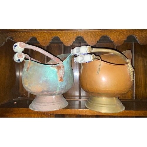 122 - TWO COPPER COAL HELMETS WITH DELFT HANDLES