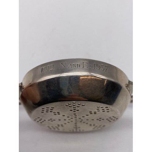 545 - SHEFFIELD SILVER TEA STRAINER WITH GEORGE VI MONOGRAM HANDLES 1.4OZ APPROX