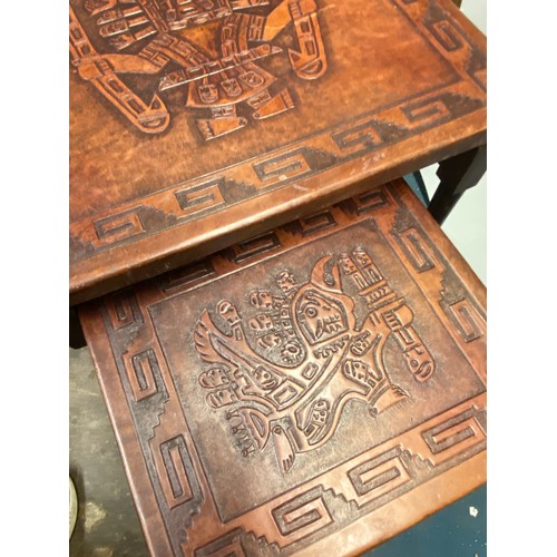 315 - LEATHER TOPPED NEST OF TWO TABLES WITH EMBOSSED AZTEC DESIGN