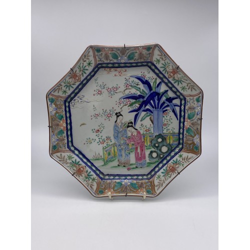 350 - JAPANESE OCTAGONAL WALL CHARGER PAINTED WITH FIGURES IN A GARDEN