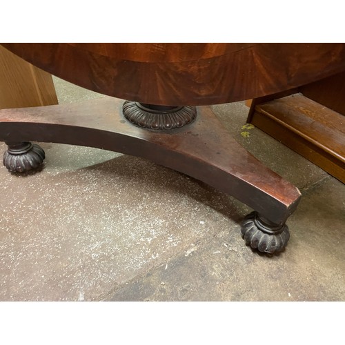 120 - GEORGE IV FLAME MAHOGANY CROSS BANDED CIRCULAR BREAKFAST TABLE WITH GADROONED EDGE ON A CARVED PEDES... 