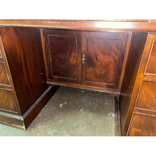 124 - GOOD QUALITY REPRODUCTION KNEEHOLE MAHOGANY NINE DRAWER DESK WITH BROWN GILT TOOLED SKIVER