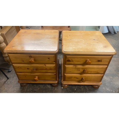 128 - PAIR OF PINE THREE DRAWER BEDSIDE CHESTS