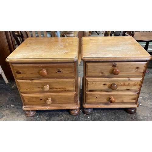 128 - PAIR OF PINE THREE DRAWER BEDSIDE CHESTS