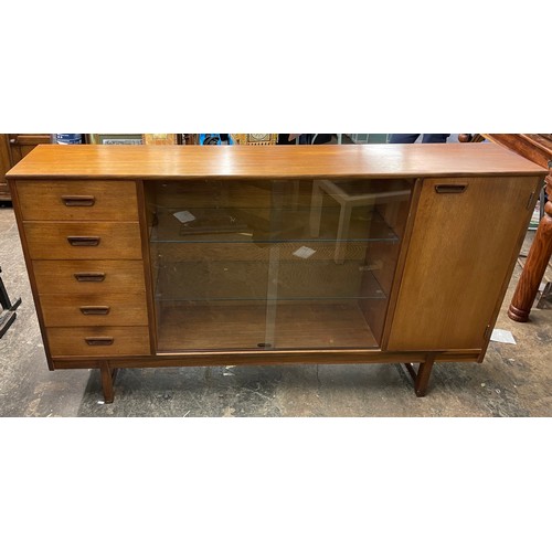 193 - 1970S TURNIDGE TEAK NARROW BOOK CASE WITH SLIDING GLASS DOORS