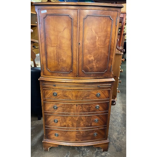 135 - YEW BOW FRONTED CABINET CHEST WITH PULL OUT SLIDE