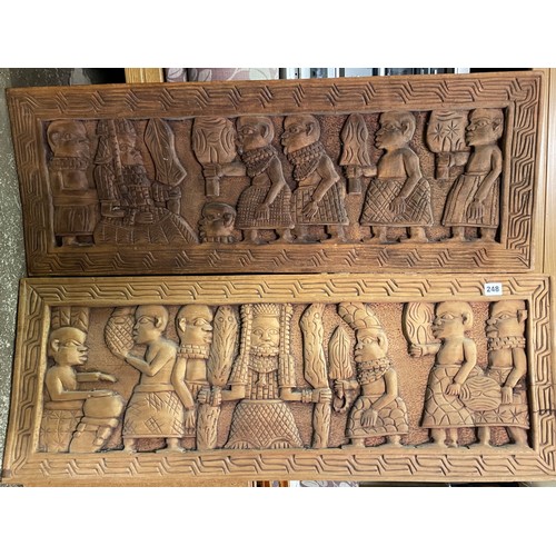 248 - PAIR OF CARVED OBLONG CARVED AFRICAN PANELS OF TRIBESMAN