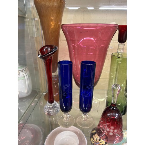 381 - SHELF OF 20TH CENTURY COLOURED GLASSWARES, RUBY AND BLUE SPILL VASES, OVOID VASE, DECORATIVE BELL