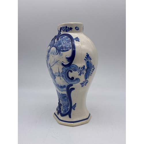 445 - DELFT BLUE AND WHITE OVOID VASE DECORATED WITH A FISHERMAN