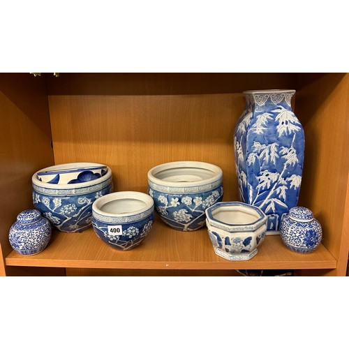 400 - SHELF OF 20TH CENTURY ORIENTAL BLUE AND WHITE PRUNUS DECORATED BOWLS AND VASES