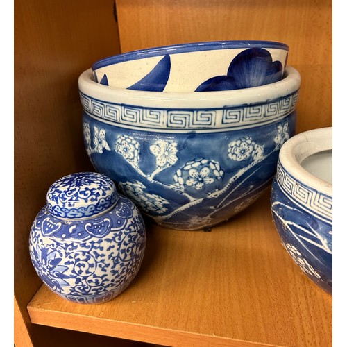 400 - SHELF OF 20TH CENTURY ORIENTAL BLUE AND WHITE PRUNUS DECORATED BOWLS AND VASES