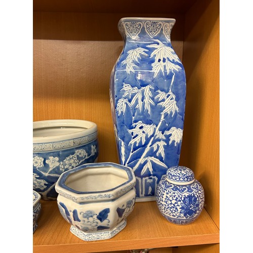 400 - SHELF OF 20TH CENTURY ORIENTAL BLUE AND WHITE PRUNUS DECORATED BOWLS AND VASES