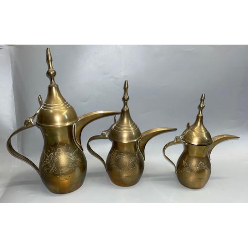 439 - PERSIAN INSPIRED ENGRAVED BRASS GRADUATED WINE EWERS