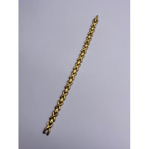 717 - UNMARKED PLATED CROSS OVER TENNIS BRACELET