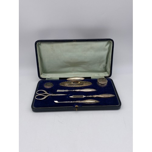 688 - CASED SILVER HANDLED SEVEN PIECE DRESSING TABLE MANICURE SET