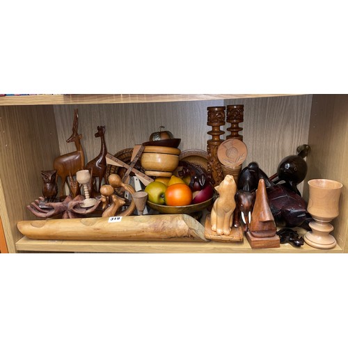 319 - SHELF OF CARVED TREEN ITEMS INC FRUIT AND BOWL, ANIMAL FIGURES, OPEN PALM, AND WINE BOTTLE HOLDER