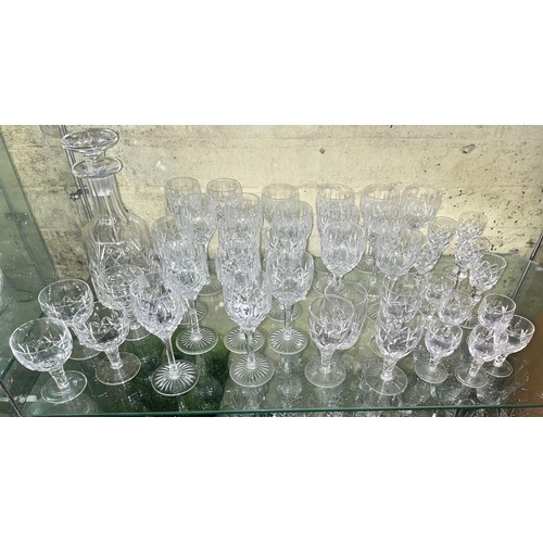 291 - SHELF OF MAINLY STUART CRYSTAL DRINKING GLASSES AND DECANTER