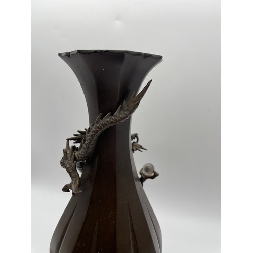 441 - JAPANESE BRONZE LOBED VASE DECORATED WITH DRAGON AND ORB ON HARDWOOD STAND