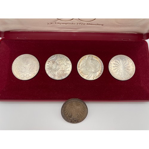 474 - CASED SET OF FOUR 1972 MUNICH OLYMPIC COINS AND ONE OTHER