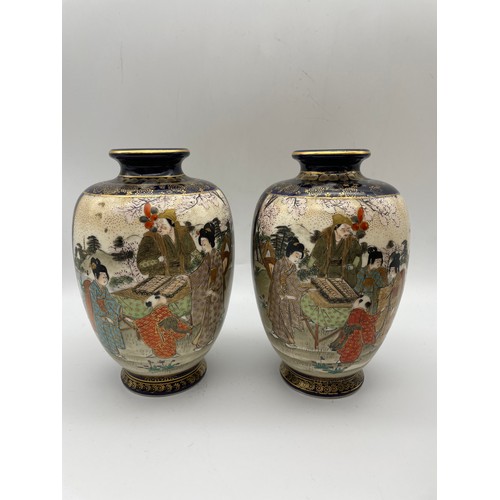 497 - PAIR OF JAPANESE SATSUMA VASES DECORATED WITH PANELS OF GEISHAS