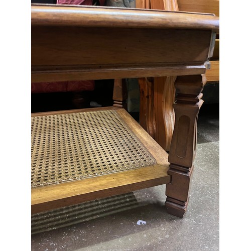 182 - WALNUT OBLONG COFFEE TABLE INSET GLASS TOP AND CANE UNDERTIER