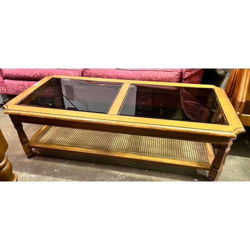 182 - WALNUT OBLONG COFFEE TABLE INSET GLASS TOP AND CANE UNDERTIER