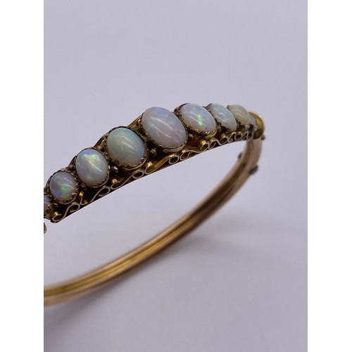 608 - 9CT NINE STONE OPAL BANGLE ON SAFETY CHAIN 9.4G OVERALL