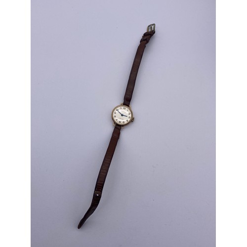 606 - LADIES 9CT GOLD CASED INGERSOLL WRIST WATCH ON LEATHER STRAP