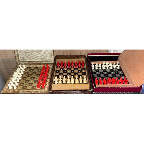 429 - THREE MINIATURE TRAVELLING CHESS SETS