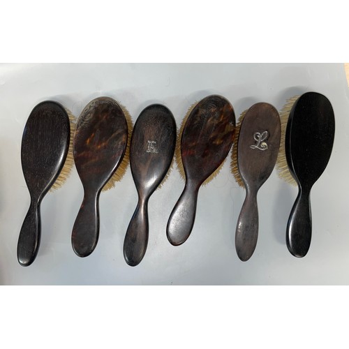 547 - SELECTION OF EBONY CARVED HAIRBRUSHES